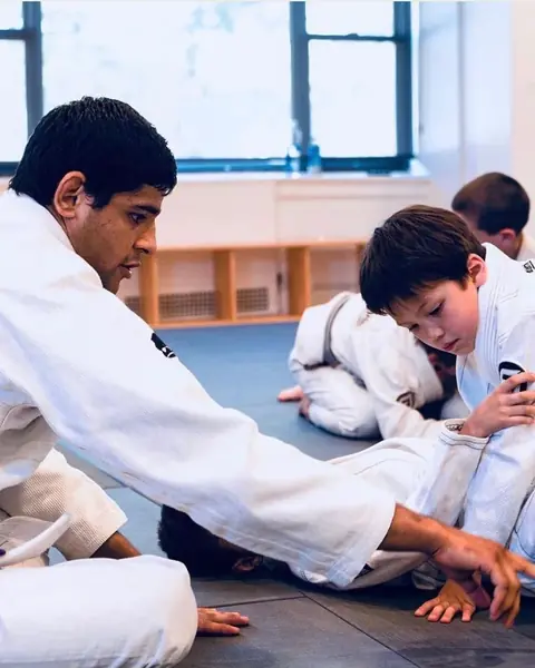 Coach helping a young student