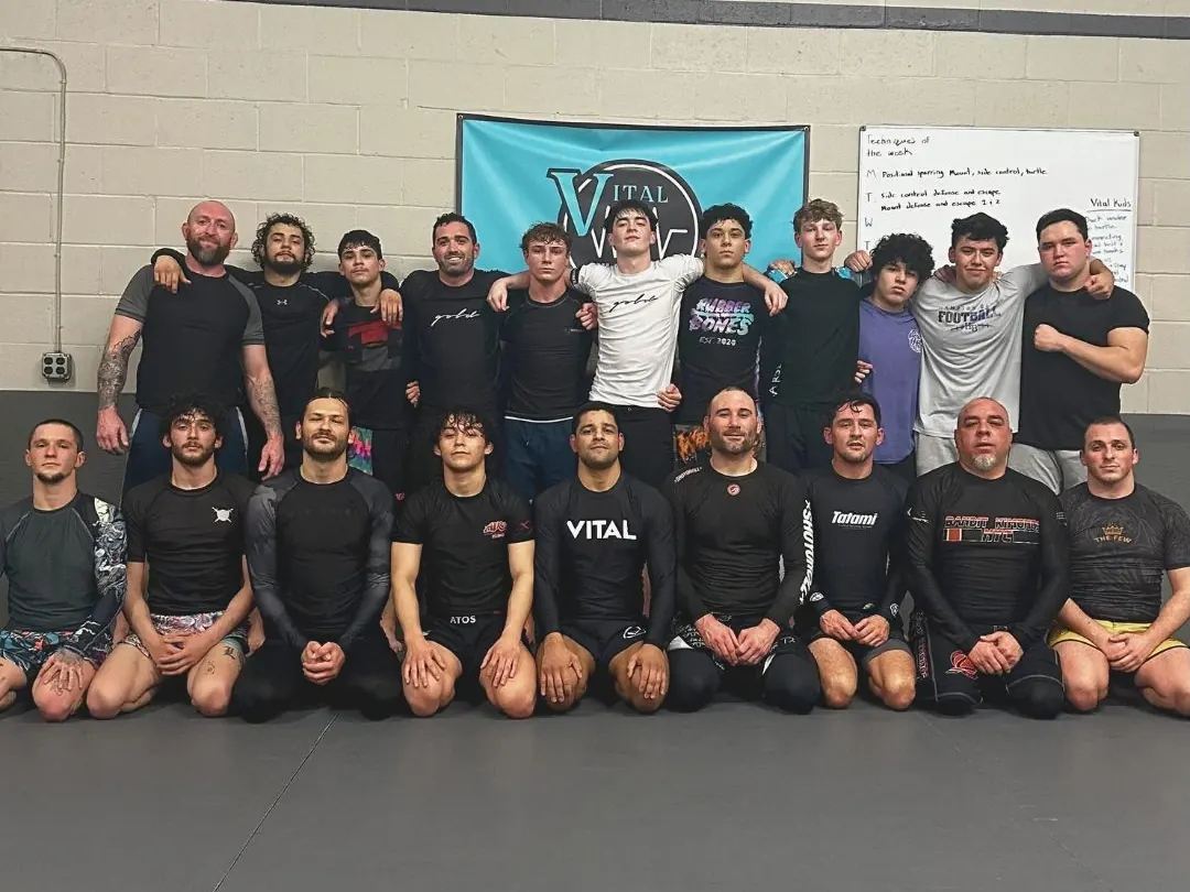 The Vital Jiu Jitsu adult team lined up on the mat under the academy banner